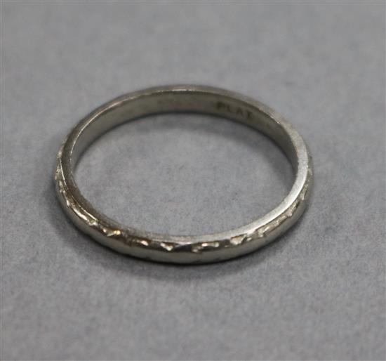 An engraved platinum wedding band, size L.